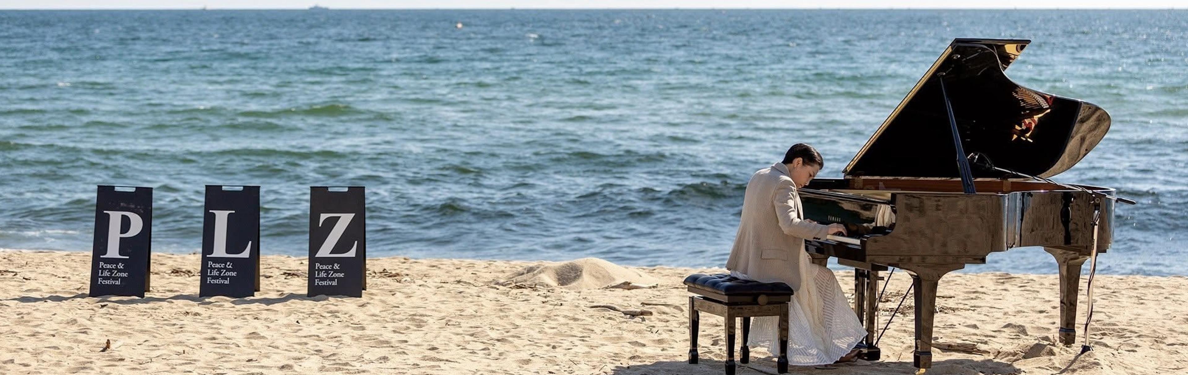 Mijung IM performing inside a transparent dome on the beach at Hwajinpo, Goseong, 2020.